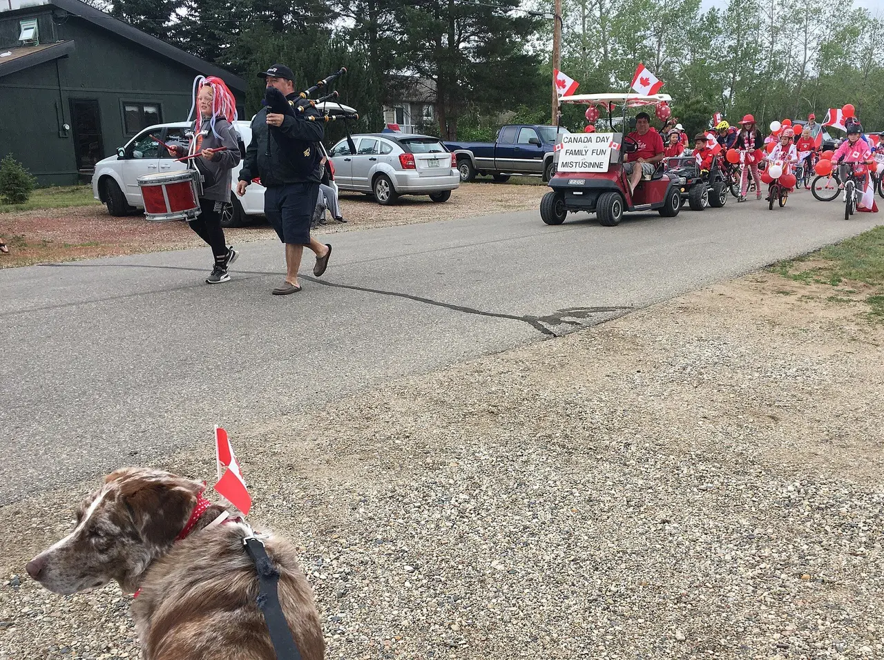 Canada Day parade with piper, drummer and decorated bikes, 2018