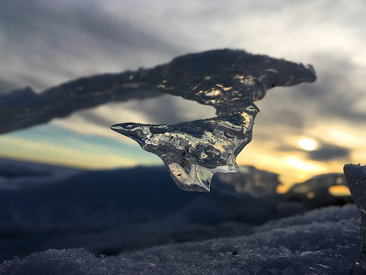 Wind-carved ice at sunset on the frozen shore, 2019